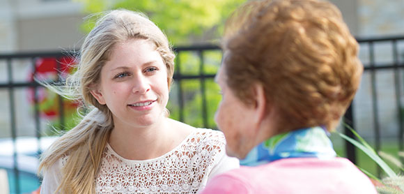 young woman having a conversation with an elderly woman